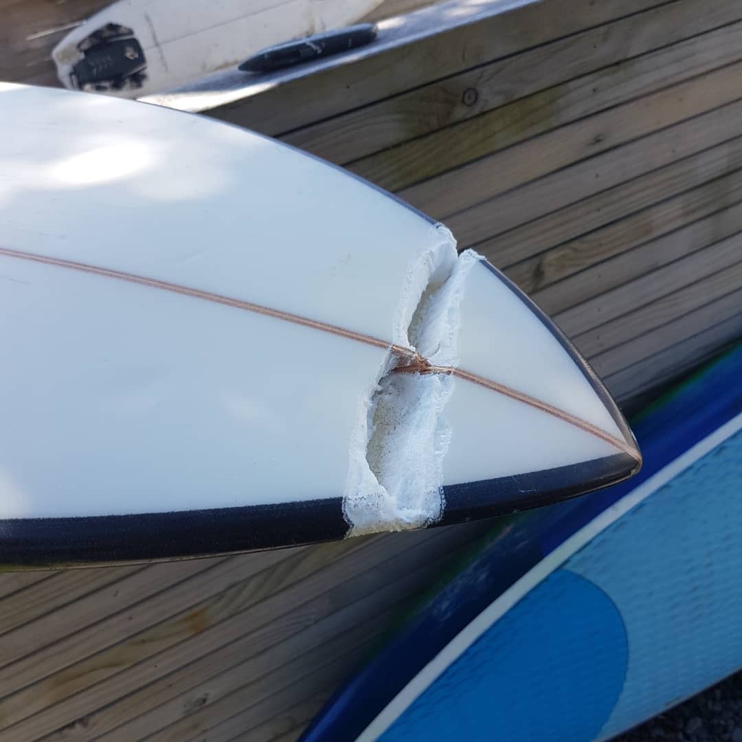 Broken nose on surfboard